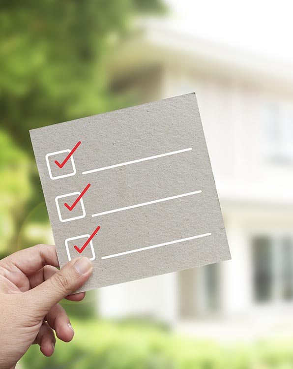 checklist van een keuring met een huis op de achtergrond